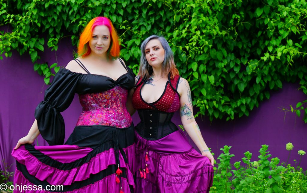 Christ wearing a Women's Satin Renaissance Style Top in black, Cotton Ruffle Skirt with adjustable hike in maroon (magenta/plum) and black nskcm3, Magenta brocade corset tt318-curvMelissa wearing black sheer waist cincher ttcinch-blk sheer, Silk Sari Turkish Style Vest with snaps snpvest, silk sari skirt with adjustable hike nskbsm3